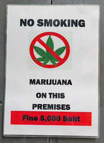 A photo of a sign in a hotel stating that the fine for smoking cannabis is 5000 Baht