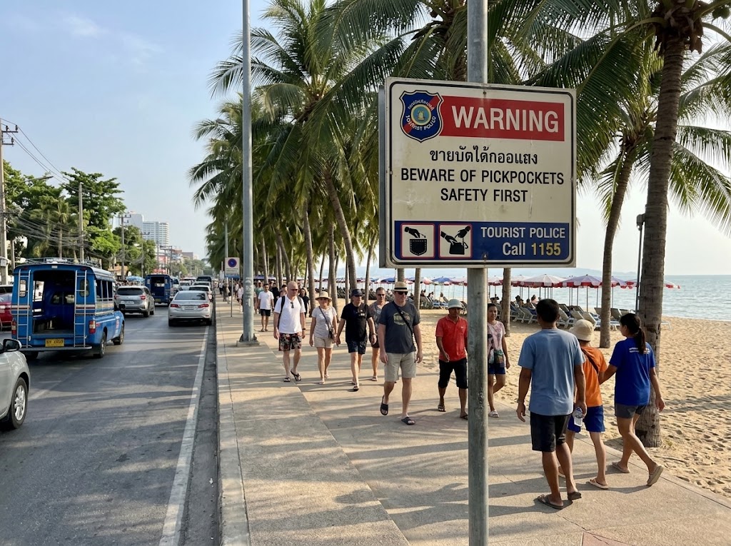 Pattaya traffic and a sign warning of pickpockets as it is an issue for Pattaya safety