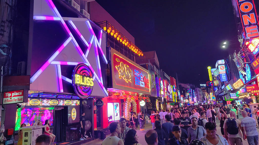 Pattaya Newbie Guide on Walking Street with bright neon signs